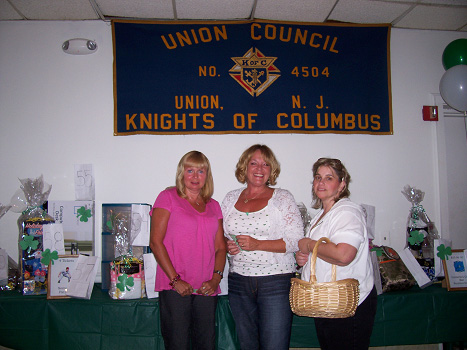 Marykay Pascullo, Kathy Noonan-Rotando and Chris Burlew setting up the room for a delightful Tricky Tray evening.